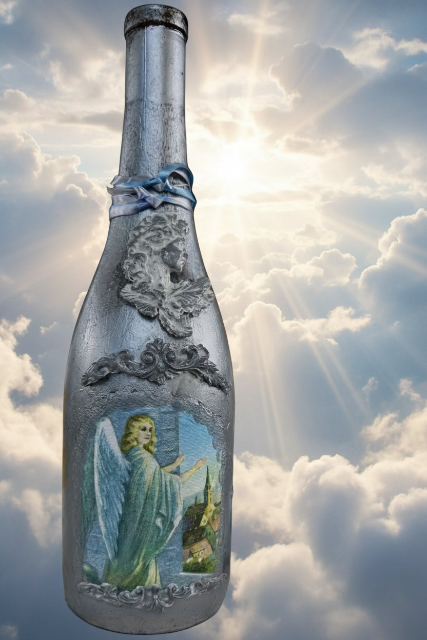Silver-toned decanter bottle with embossed angel relief and blue panel