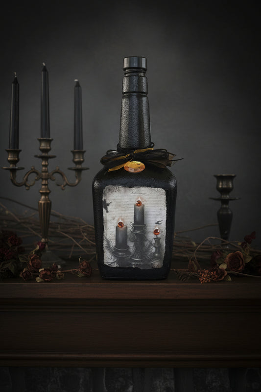 Decorative black jar candle with three wicks and embossed scene, gothic style