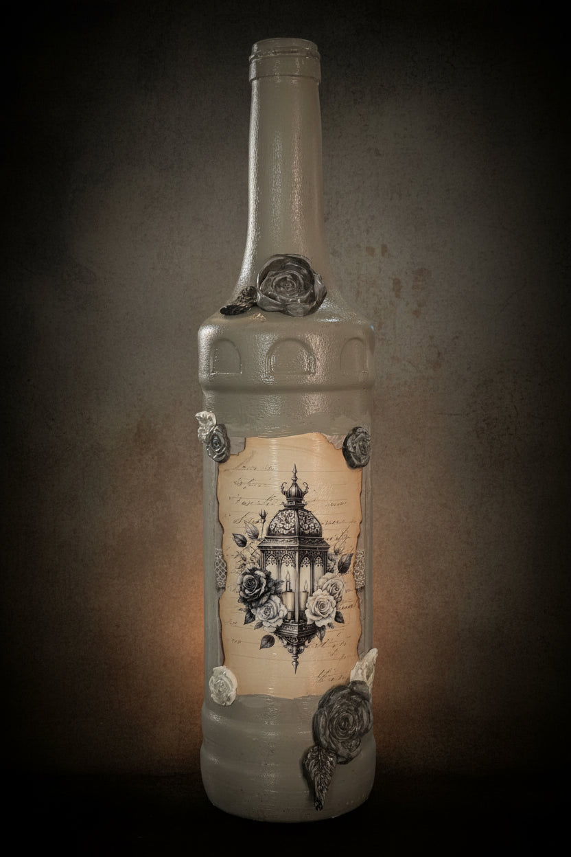 Grey decorative glass bottle with carved rosette accents and wrapped label